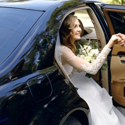 Full size bottom view young traveler businessman young man in black dinner suit going walk outside at international airport terminal with suitcase to car booking taxi Air flight business trip concept.